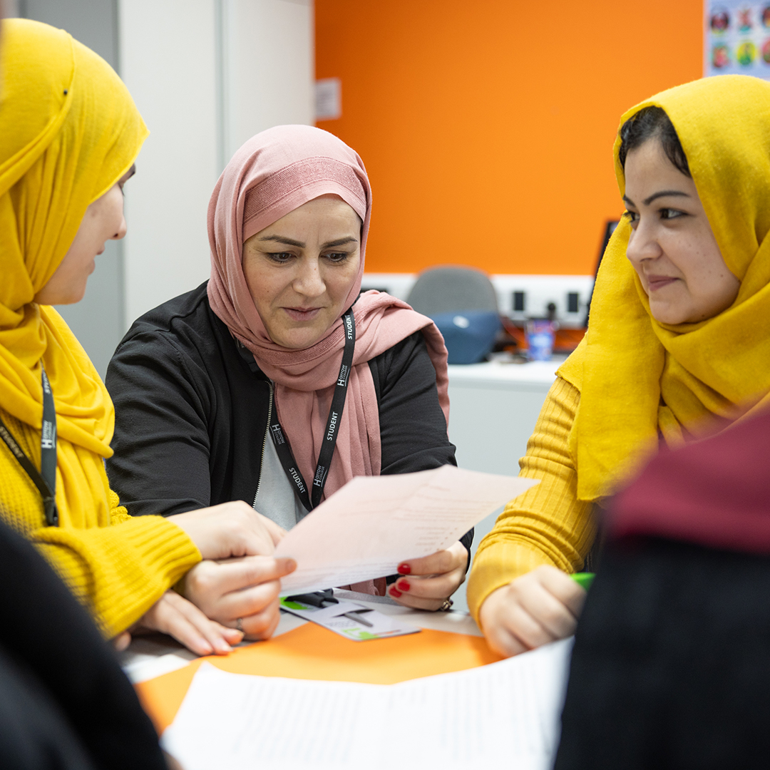 Female Harrow College students studying together around a table