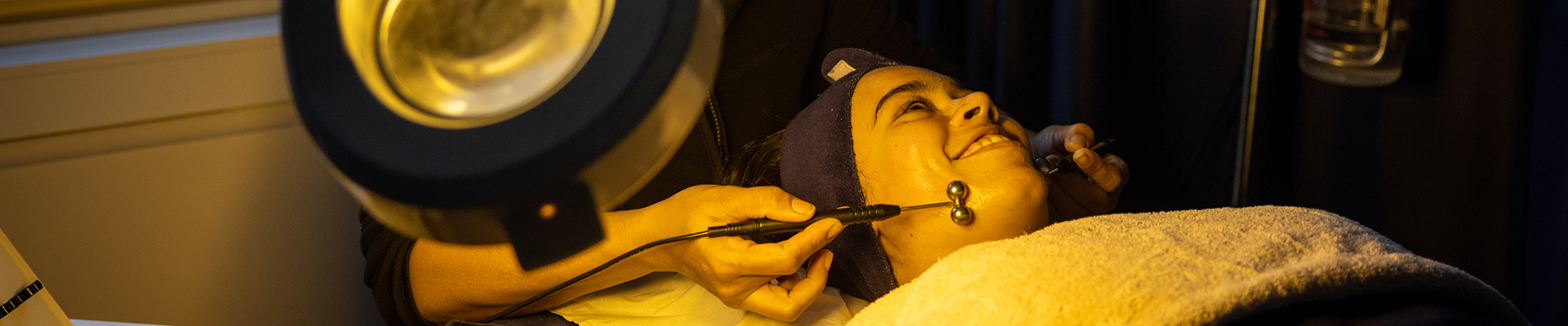 Harrow Beauty Therapy students practicing facial roller techniques