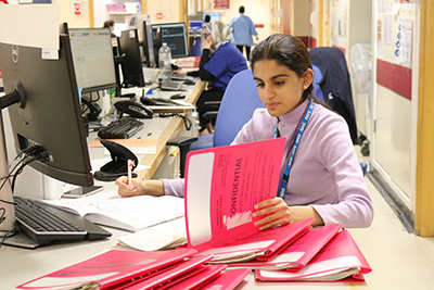 Project Search Work Training Programme student at Northwick Park Hospital, looking at patient files.
